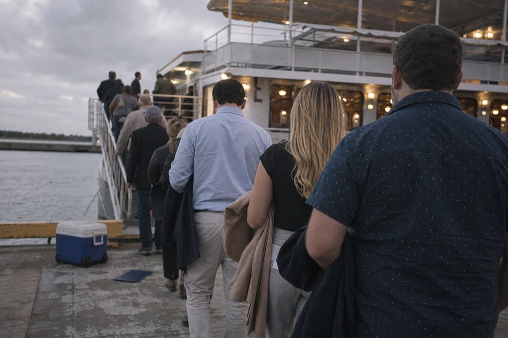 Passengers boarding a dinner cruise boat at a San Diego pier in the early evening, no text, no logos, no people