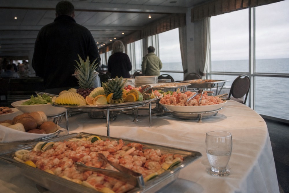 A buffet dinner spread set out on a cruise ship dining table, no text, no logos, no people