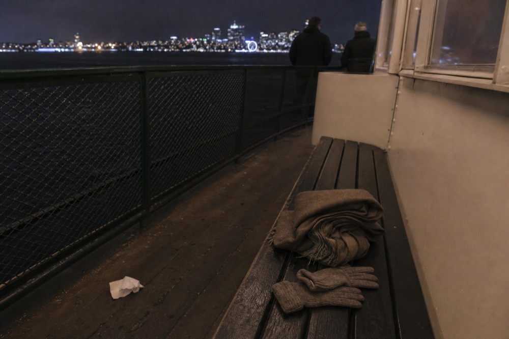 Warm evening attire on a boat deck with city lights across San Diego Bay, no text, no logos, no people