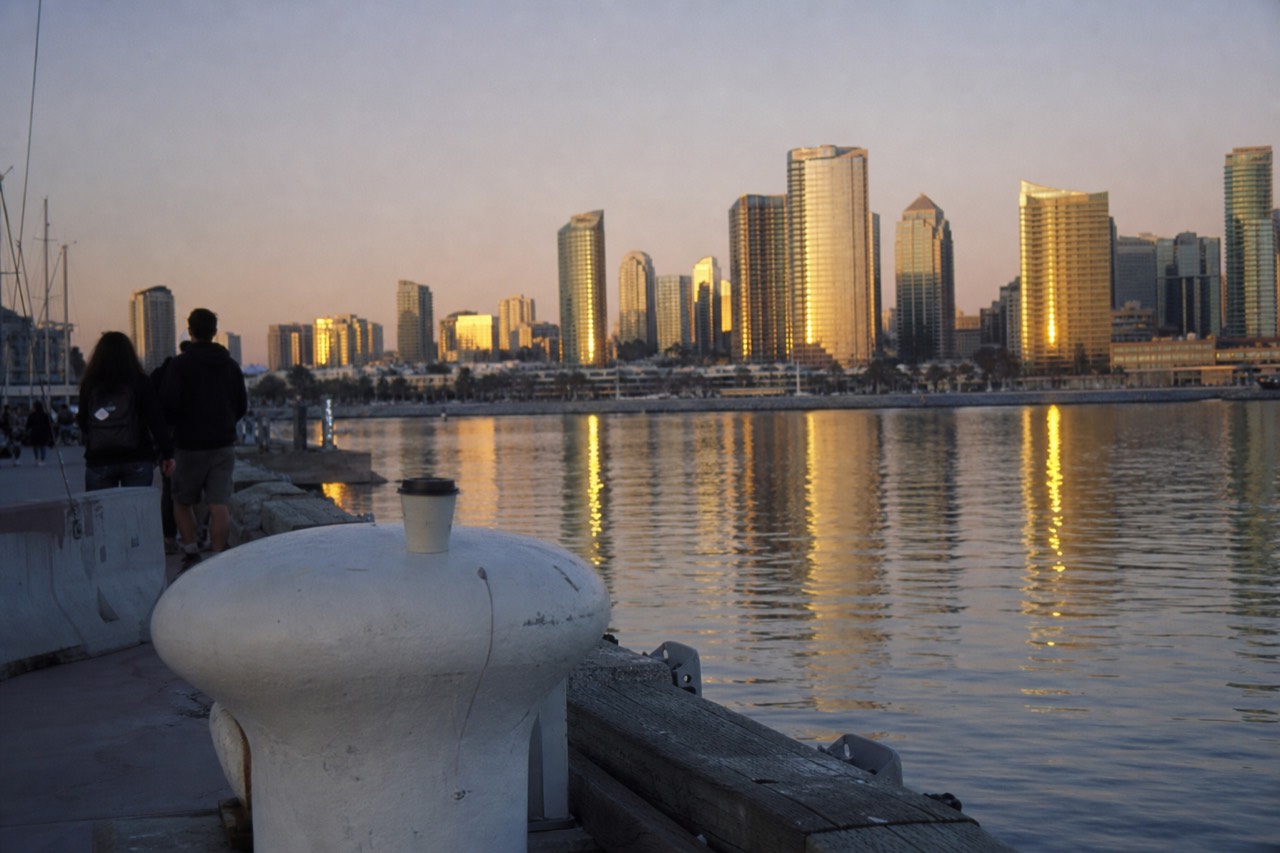 San Diego Bay at dusk with city lights reflecting on the water, no text, no logos, no people