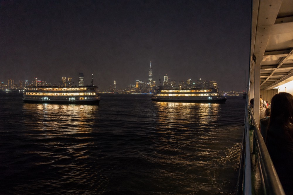 Two dinner cruise boats passing each other on San Diego Bay at twilight, no text, no logos, no people