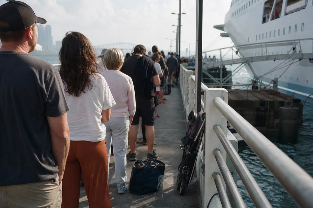 Passengers boarding a cruise vessel at a San Diego Bay pier on a weekend morning, no text, no logos, no people