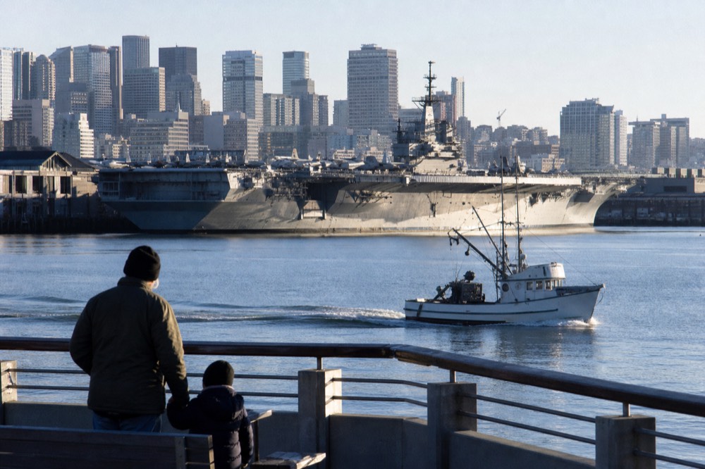 The USS Midway Museum and downtown skyline seen from the water, no text, no logos, no people