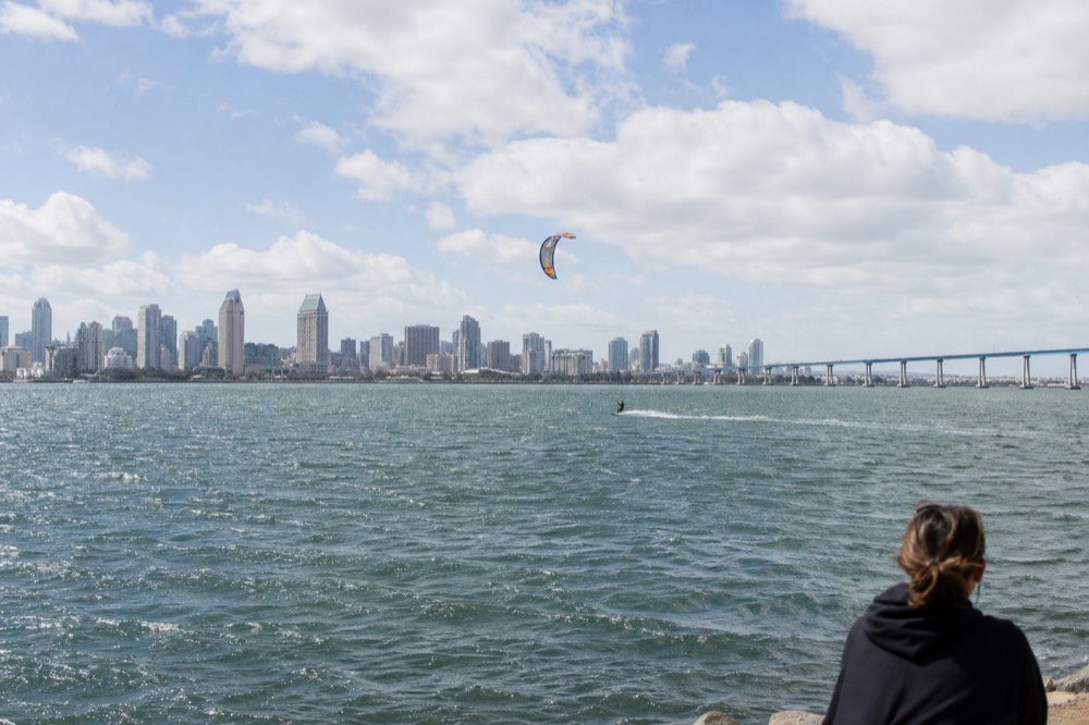 Wide view of San Diego Bay with the downtown skyline and Coronado Bridge in the distance, no text, no logos, no people