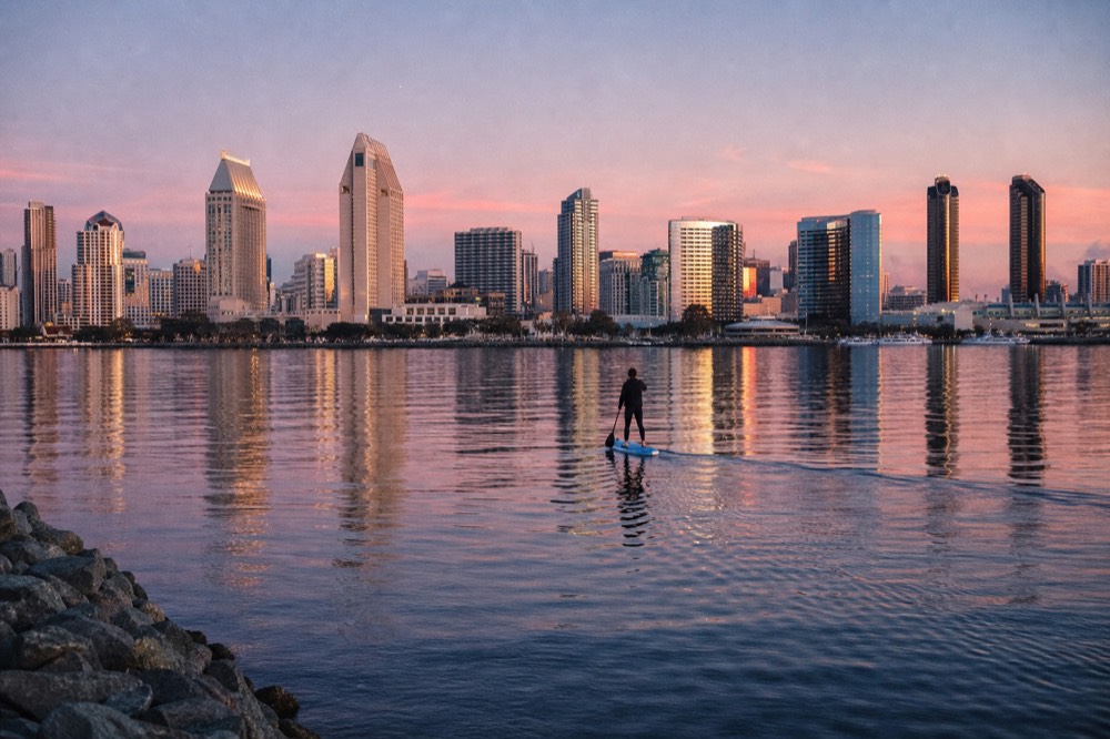 The downtown San Diego skyline seen across the water in the final minutes of sunset, no text, no logos, no people